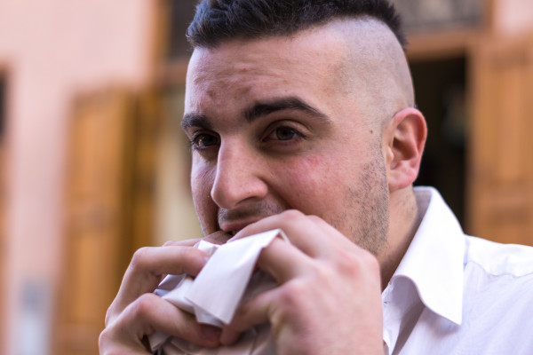 French guy eating Moroccan street food wrap